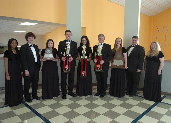North Lamar High School senior band members display trophies won by the Symphonic and Concert Bands.  From left are Taleia Anderson, Cory Burchfield, Dani Hicks, Grant Erickson, Arilynn Hostetler, Jake Briscoe, Sydney Wilson, Alfredo Berg and Faith Vickery.